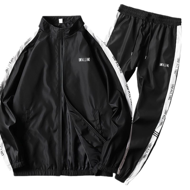 Tuta sportiva nera unisex, giacca e pantaloni con strisce bianche laterali, scritta "UNFALLING", abbigliamento casual e alla moda.