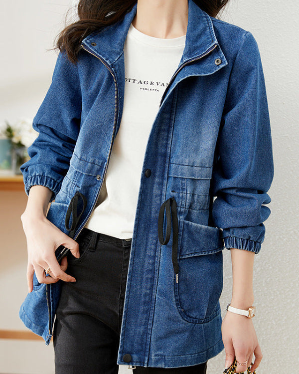 Giacca di jeans blu casual da donna con cerniera, tasche frontali e coulisse, indossata su maglietta bianca. Moda femminile, abbigliamento casual.