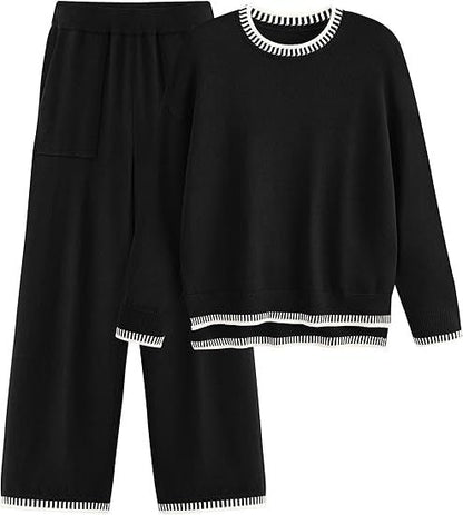 Set coordinato donna nero, maglione e pantaloni larghi, dettagli a righe bianche, moda autunno inverno, abbigliamento casual elegante.