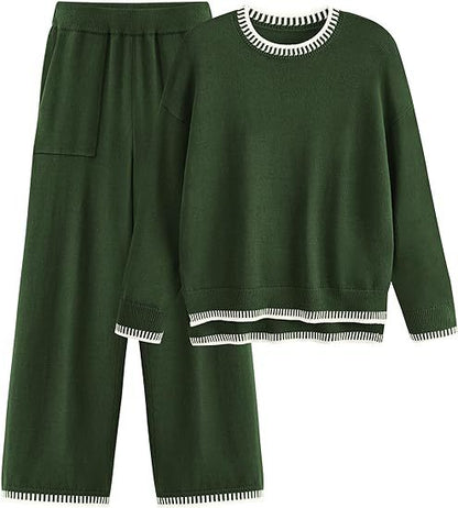 Completo donna verde scuro, maglione e pantaloni larghi, dettagli a righe bianche, abbigliamento casual elegante, moda autunno inverno.