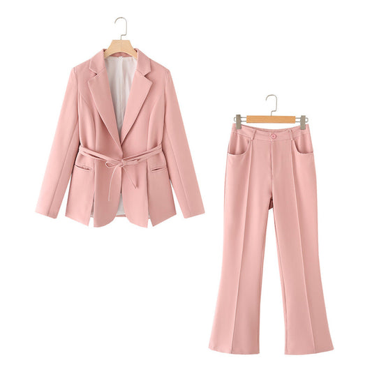 Completo donna elegante rosa, giacca con cintura e pantaloni a vita alta. Moda femminile, abbigliamento formale, tendenze 2023.