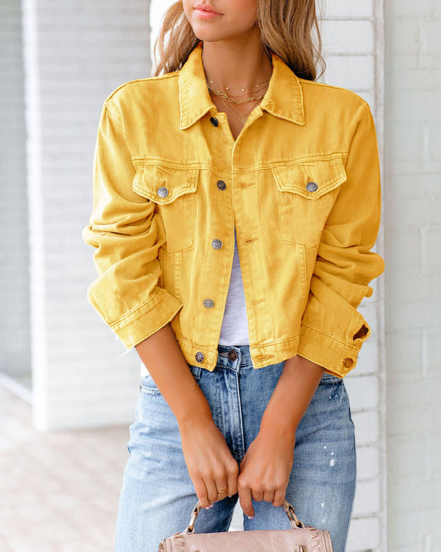 Giacca di jeans gialla su donna, abbinata a jeans blu e top bianco. Moda casual femminile, stile primaverile, tendenze abbigliamento 2023.
