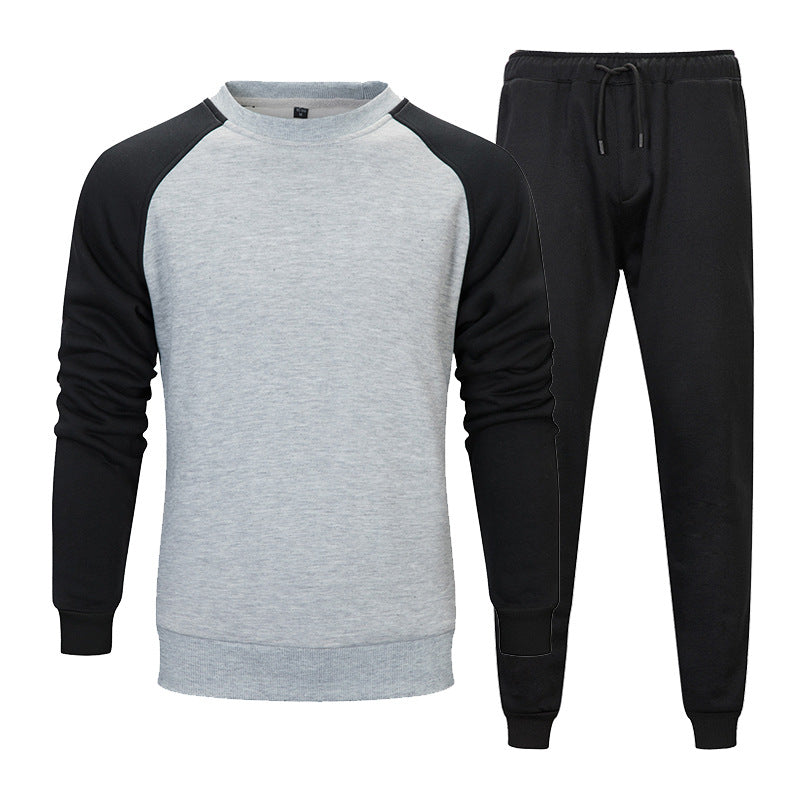 Tuta sportiva uomo, felpa grigia con maniche nere e pantaloni neri, abbigliamento casual, moda comoda, ideale per palestra e tempo libero.
