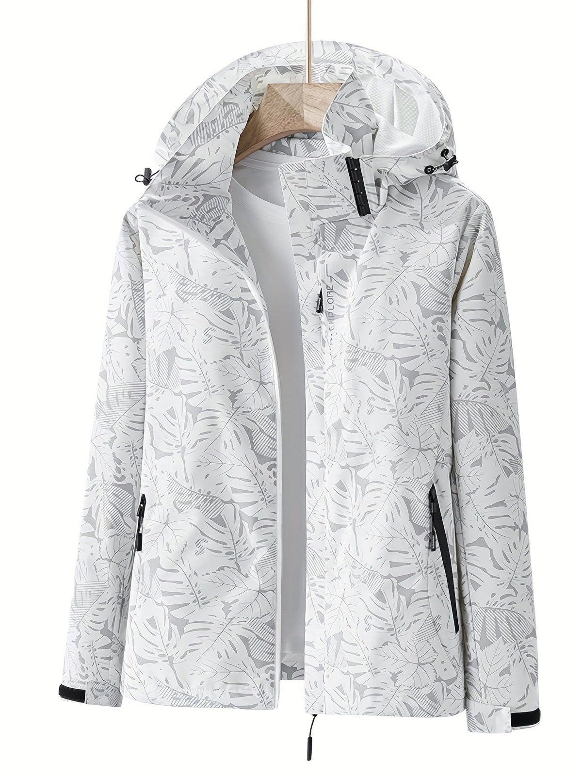 Giacca a vento bianca con cappuccio, motivo foglie tropicali, chiusura zip, tasche laterali, ideale per outdoor e sport. Moda donna autunno.