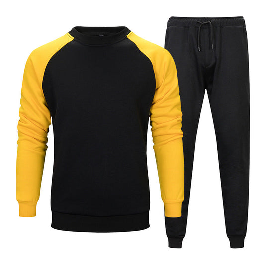 Tuta sportiva uomo, felpa nera con maniche gialle e pantaloni neri, abbigliamento casual, moda autunno, stile confortevole e moderno.