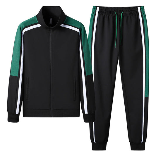 Tuta sportiva nera con dettagli verdi e bianchi, composta da giacca con zip e pantaloni con elastico. Abbigliamento atletico moderno e casual.