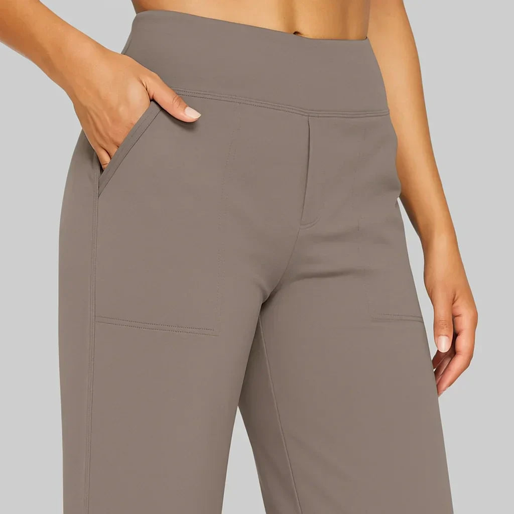 Pantaloni sportivi donna grigi con tasche, vita alta, tessuto elasticizzato. Ideali per yoga, fitness, abbigliamento comodo.