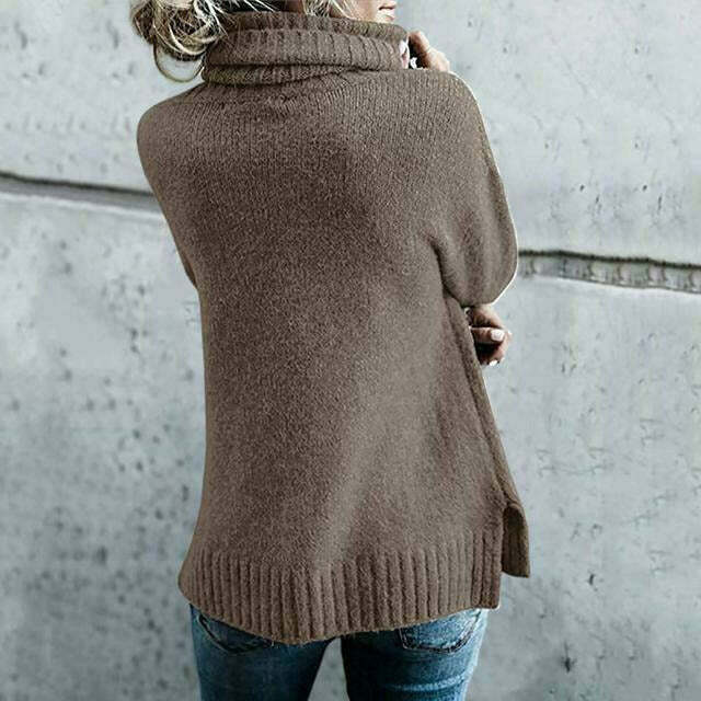 Donna con maglione marrone a collo alto, stile casual, di spalle. Moda autunnale, abbigliamento caldo, sfondo grigio.