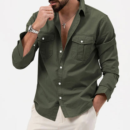 Camicia verde militare da uomo con tasche frontali e bottoni bianchi, indossata con pantaloni chiari. Stile casual elegante, moda maschile.