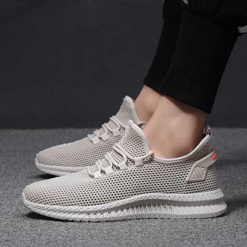 Scarpe da ginnastica beige unisex, design moderno in tessuto traspirante, suola antiscivolo, ideali per sport e tempo libero.