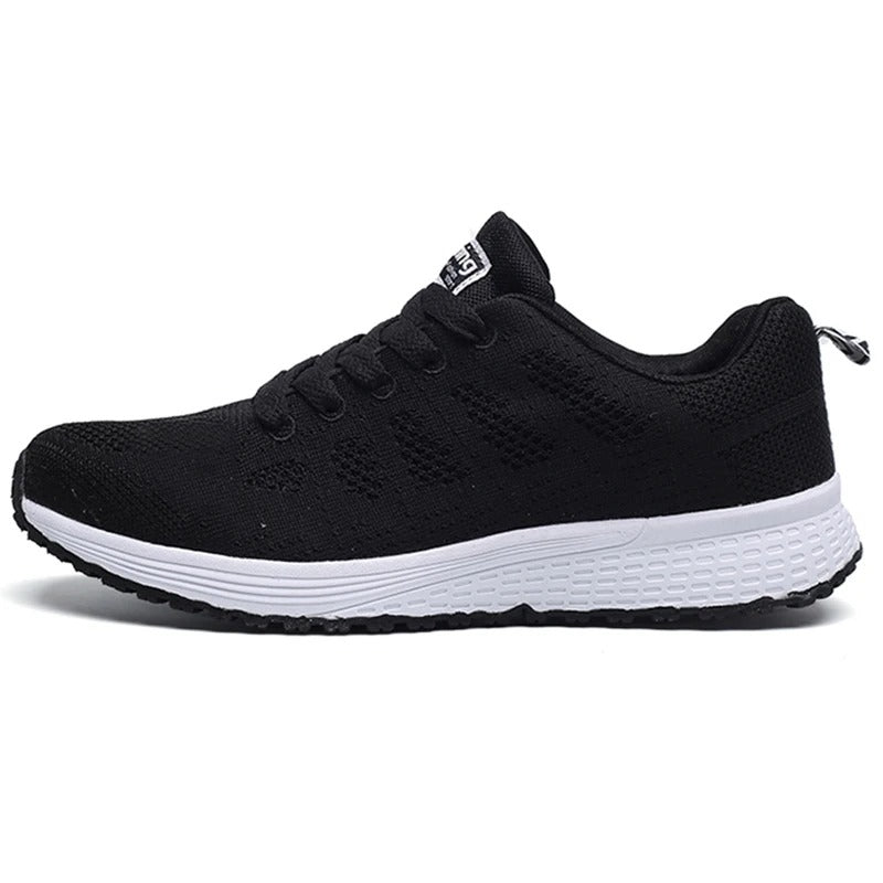 Scarpa da ginnastica nera unisex, design traspirante, suola bianca antiscivolo. Ideale per corsa e sport. Stile moderno e confortevole.