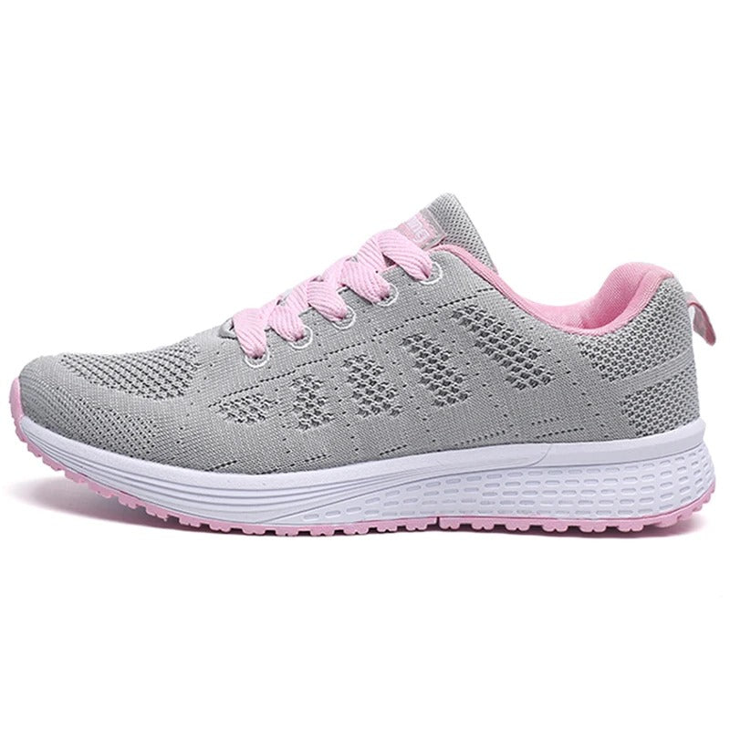 Scarpa da ginnastica grigia e rosa con suola bianca, design traspirante, ideale per corsa e sport. Scarpe sportive donna, comfort e stile.